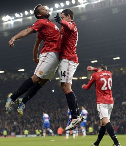 Javier Hernandez (R) and team-mate Anderson celebrate the Mexican forward's goal, at Old Trafford, on February 18, 2013